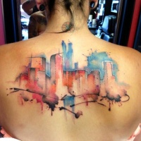 Watercolor style back tattoo of city buildings