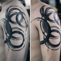 Watercolor style black ink shoulder tattoo of various circles