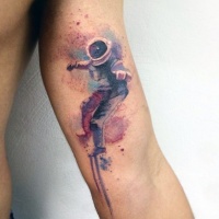 Watercolor style colored biceps tattoo of spaceman