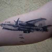 Watercolor style colored biceps tattoo of big bomber plane