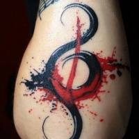 Watercolor style colored forearm tattoo of music note