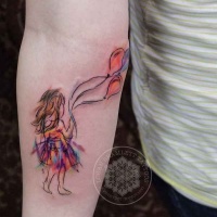 Watercolor style colored forearm tattoo of girl with balloons
