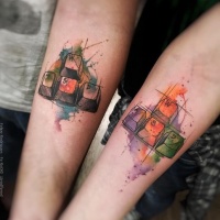 Watercolor style colored forearm tattoo of keyboard keys