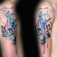 Watercolor style colored shoulder tattoo of snowboarder with snowflake