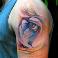 Watercolor style cute looking shoulder tattoo of woman eye stylized with triangles