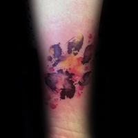 Watercolor style detailed arm tattoo of dog paw print