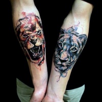 Watercolor style forearm tattoo of various lions