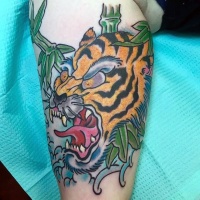 Watercolor style homemade leg tattoo of roaring tiger with leaves