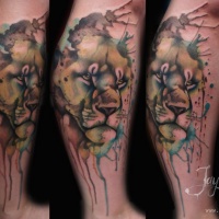Watercolor style interesting looking leg tattoo of lion head
