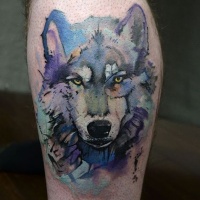Watercolor style nice looking leg tattoo of wolf head