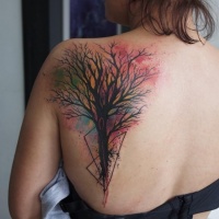 Watercolor style painted colorful tree tattoo on back with black triangle