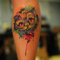 Watercolor style painted multicolored forearm tattoo of smiling cat