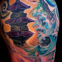 Watercolor style painted shoulder tattoo of old Asian temple and mountains
