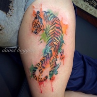Watercolor tattoo of crawling tiger on leg