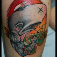 Whale with cap tattoo on thigh