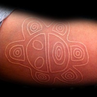 White ink style small ancient symbol tattoo