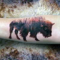 Wild bull shaped arm tattoo stylized with colored forest