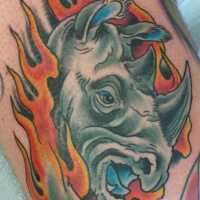Wild rhino tattoo running in fire