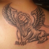 Winged lion tattoo on back