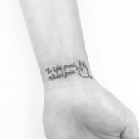Wise thin lettering and tiny white pigeon wrist tattoo