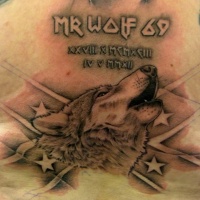 Wolf with an american flag and inscription tattoo on chest