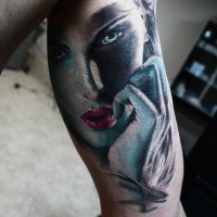 Woman face tattoo on arm