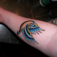 Women's vivid-colored sparrow bird tattoo on forearm