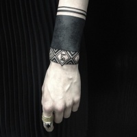 Wonderful blackwork wrist tattoo by Sasha Masiuk