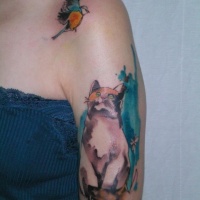 Wonderful watercolor cat with bird tattoo on shoulder