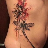 Wonderful watercolor dragonfly tattoo on ribs