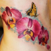 Wonderful watercolor orchids with yellow butterfly tattoo