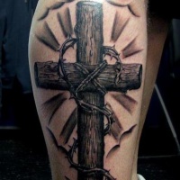Wooden cross with a thorny branch tattoo on half sleeve