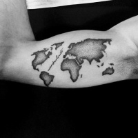 World map black and white tattoo on biceps with lettering