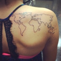 World map thin black ink contour tattoo on woman's upper back