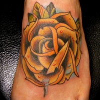 Yellow rose with dew drops tattoo on foot