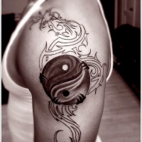 Tatuaggio sul braccio il disegno nero in stile Yin-Yang