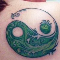 Tatuaggio sulla spalla il disegno verde in stile Yin-Yang