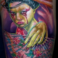 Zombie like colorful crying Asian woman tattoo on thigh with fan