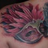 3D style modern colored shoulder tattoo of woman eye with mask and feather