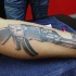 3D style very detailed AK rifle tattoo on arm
