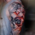 Awesome skull and flowers tattoo on shoulder