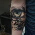 Biomechanical eye tattoo on forearm