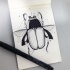 Black-and-white bug with geometric dotted lines tattoo design