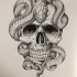 Black-and-white snake lying on skull tattoo design