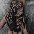 Black and white Joker tattoo on wrist