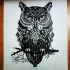 Black owl sitting on tree branch tattoo design