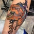 Cool dinosaur tattoo on leg