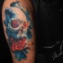 Cool skull and rose tattoo on shoulder