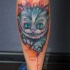 Cute Cheshire Cat tattoo on leg