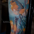 Cute colorful bird tattoo on sleeve